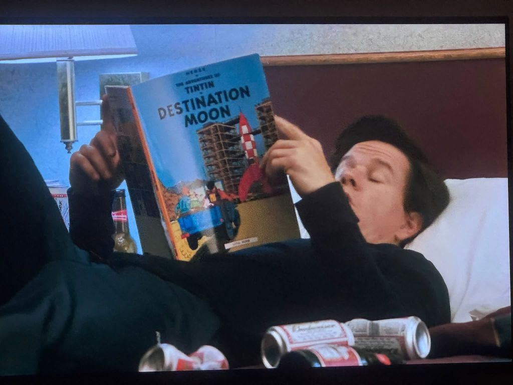 Mark Wahlberg as John Bennett reading Hergé's Destination Moon in a hotel room in Ted (2012)